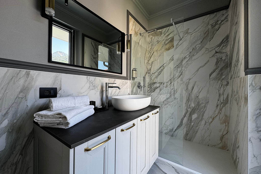 Completed modern bathroom renovation with dark vanity